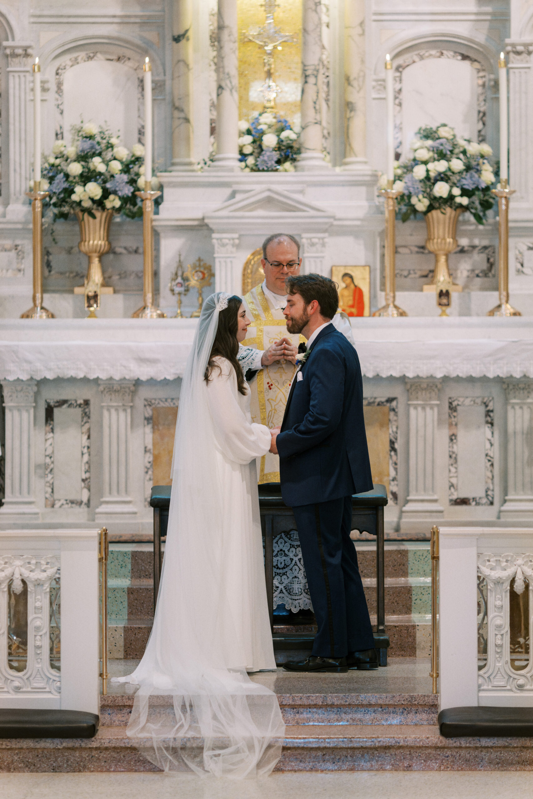 Bride and groom at the altar of Holy Rosary Catholic Church in Indianapolis 